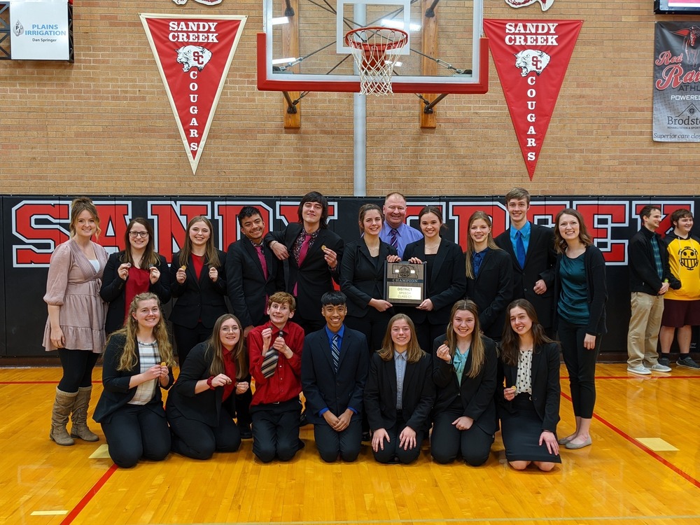 speech students holding award for tournament win 